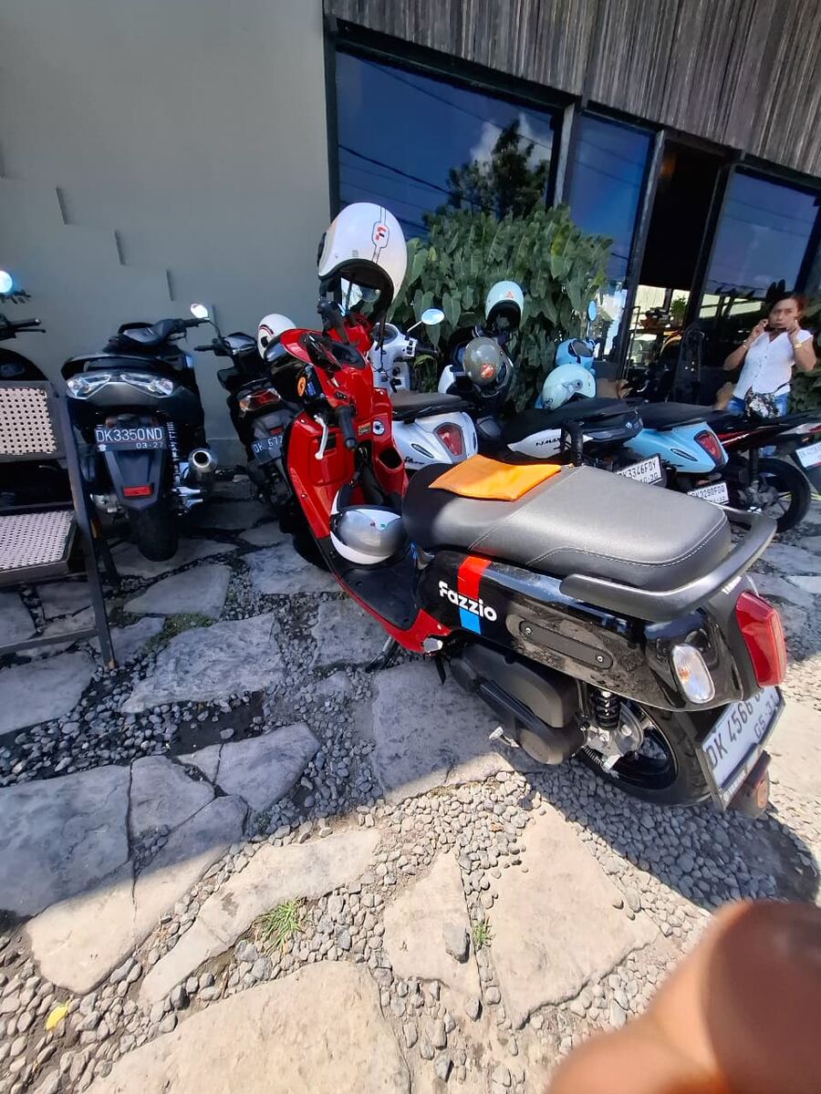 Row of Yamaha Fazzio motorbikes ready to rent