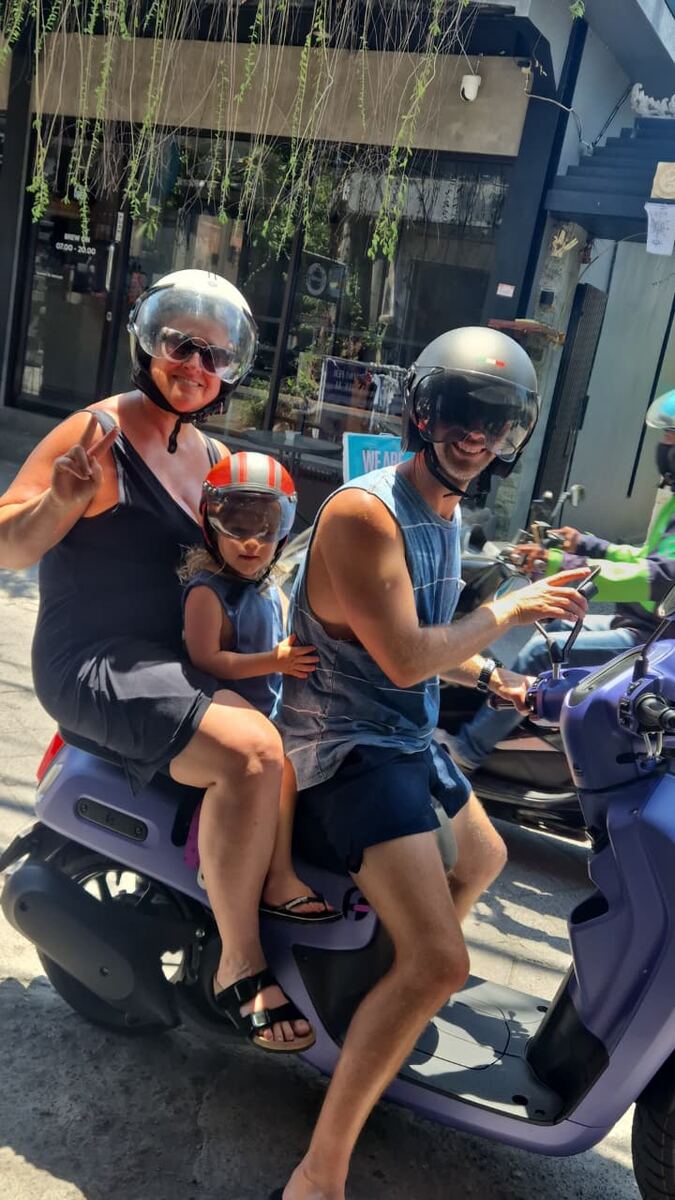 Family riding a rental motorbike in Bali